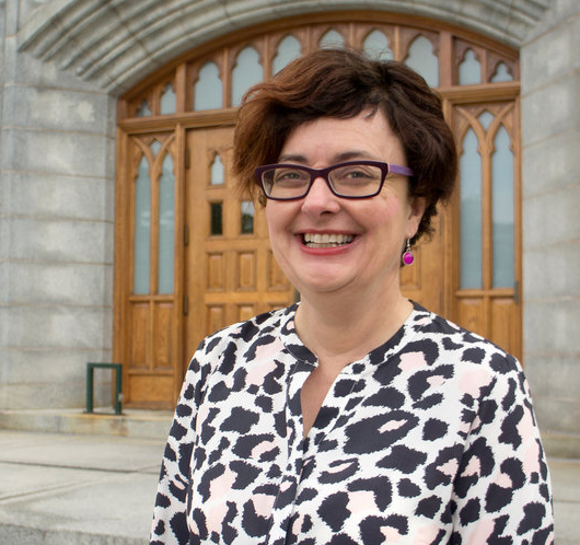 Dr. Margaret Y. MacDonald standing at the doors of Saint Mary's University, where she is a professor.